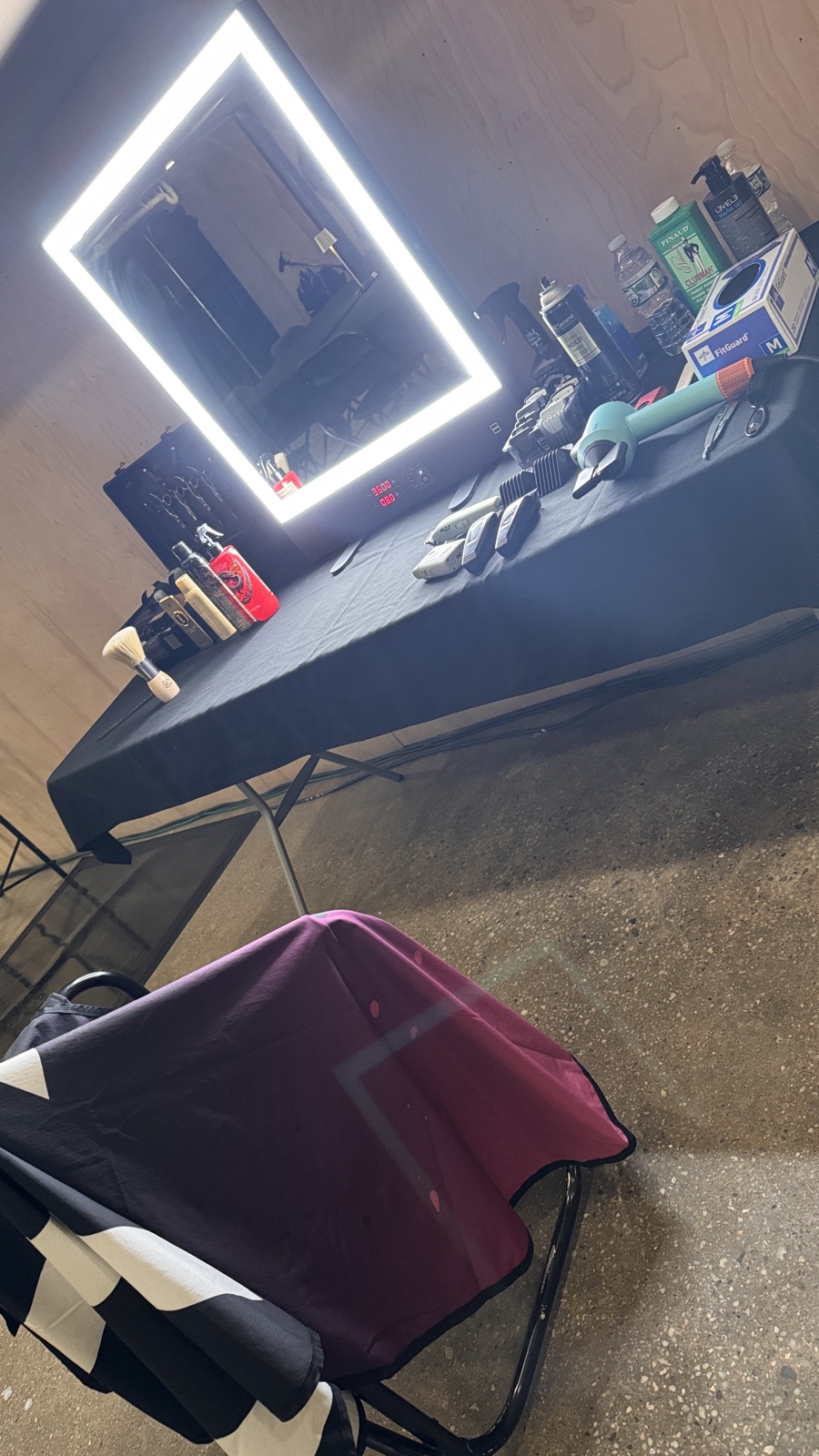 Marvin Suarez's fully equipped mobile grooming station — lit mirror, clippers and products — set up on location